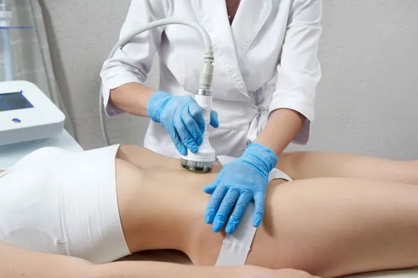 Lost the Weight but Not the Loose Skin? 2 woman having HIFU treatment on her stomach to combat loose skin Chigwell following weight loss